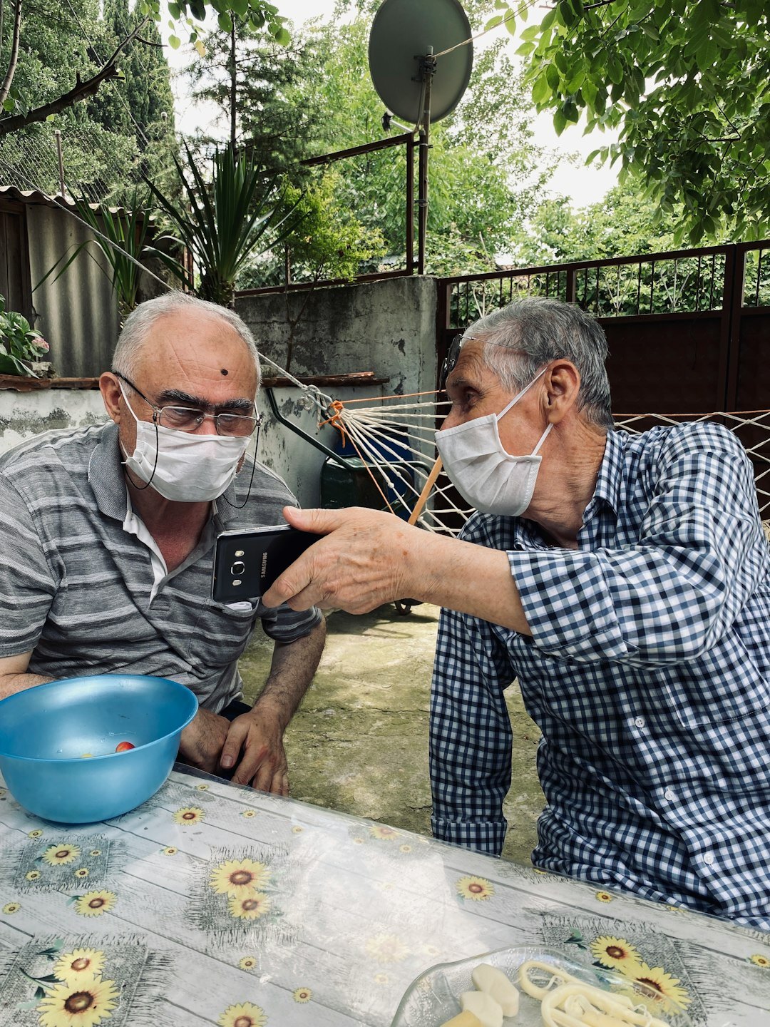 elderly man sharing cake with neighbor