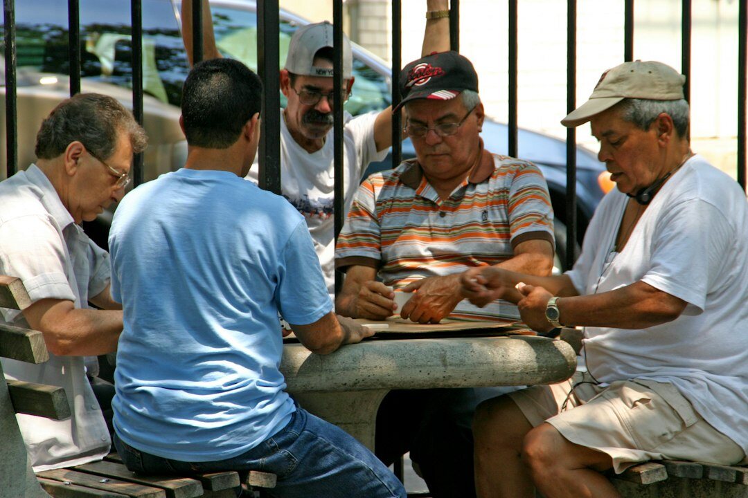 group of elderly friends playing cards